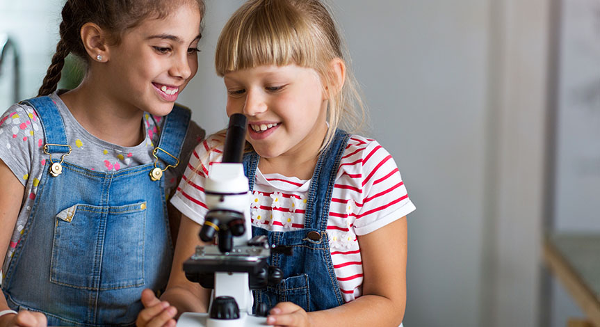Girls looking at microscope